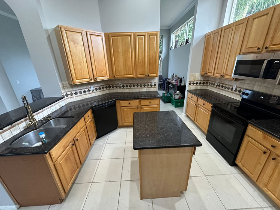 Worn kitchen cabinetry before painting
