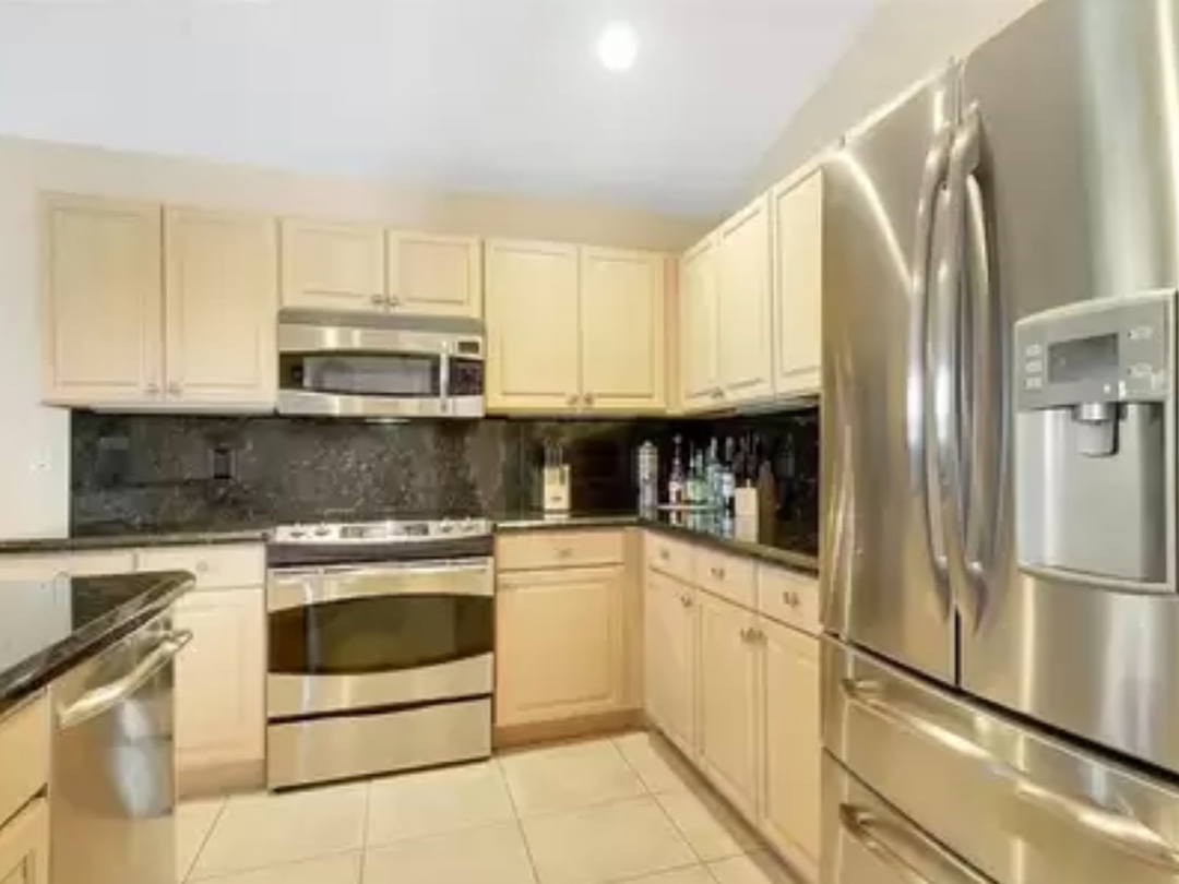 Kitchen island and cabinets before being repainted