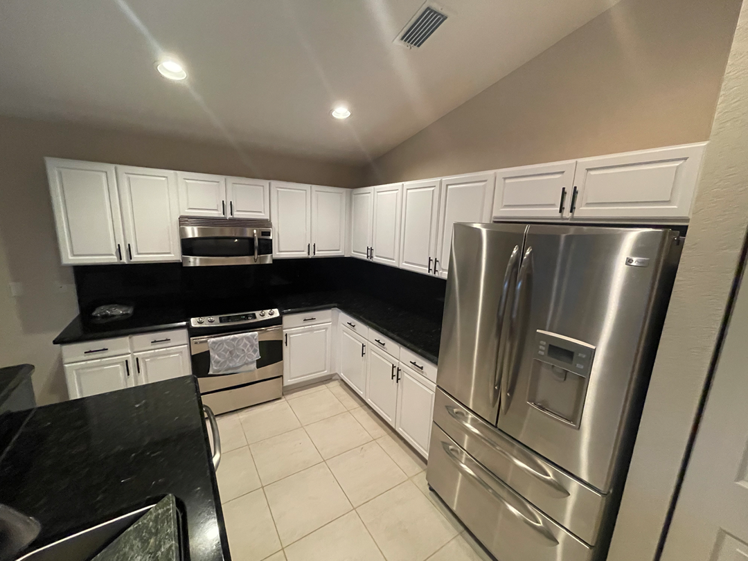 Kitchen island and cabinets after being repainted