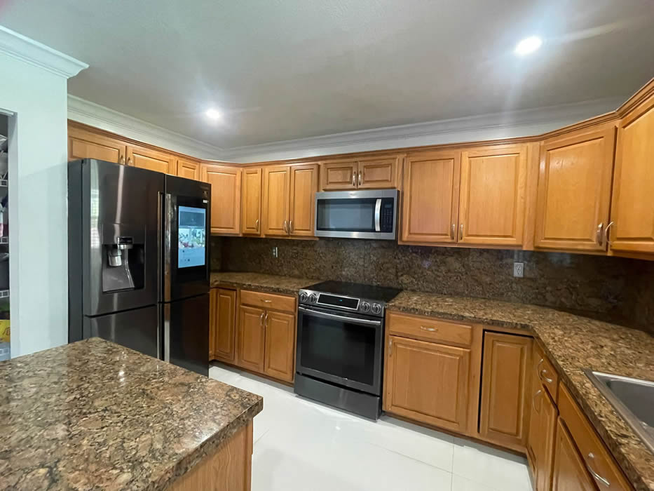 Kitchen before cabinet refinishing in South Florida